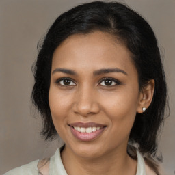 Joyful black young-adult female with medium  brown hair and brown eyes