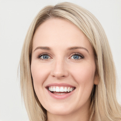 Joyful white young-adult female with long  brown hair and blue eyes