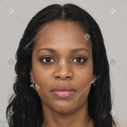 Joyful black young-adult female with long  brown hair and brown eyes