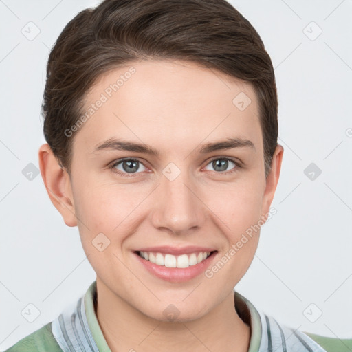 Joyful white young-adult female with short  brown hair and grey eyes