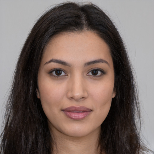 Joyful latino young-adult female with long  brown hair and brown eyes