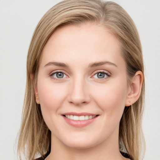 Joyful white young-adult female with long  brown hair and blue eyes