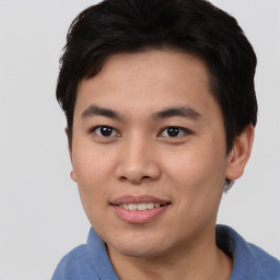 Joyful asian young-adult male with short  black hair and brown eyes