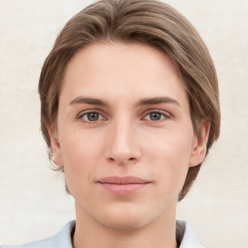 Joyful white young-adult female with short  brown hair and grey eyes