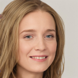 Joyful white young-adult female with long  brown hair and blue eyes