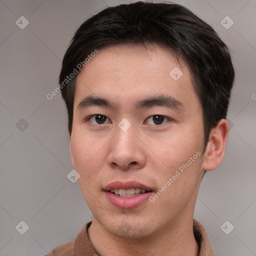 Joyful asian young-adult male with short  brown hair and brown eyes