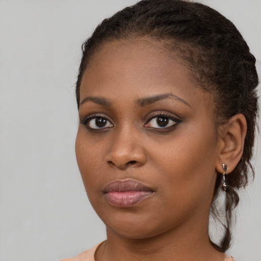 Joyful black young-adult female with medium  brown hair and brown eyes