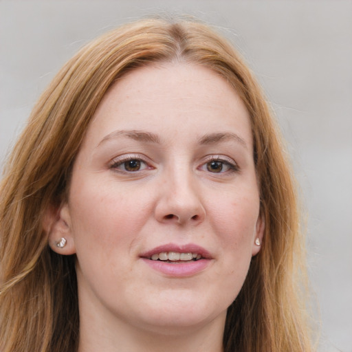 Joyful white young-adult female with long  brown hair and blue eyes