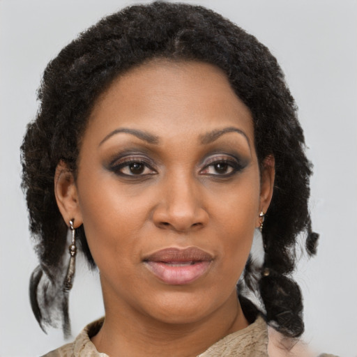 Joyful black adult female with medium  brown hair and brown eyes