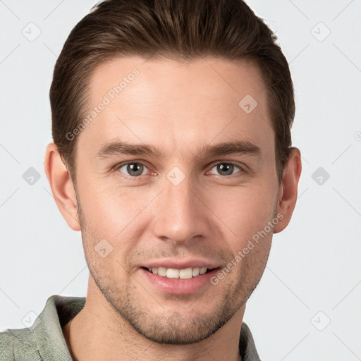 Joyful white young-adult male with short  brown hair and grey eyes