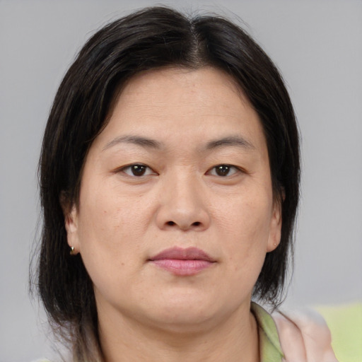 Neutral asian adult female with medium  brown hair and brown eyes