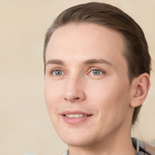 Joyful white young-adult male with short  brown hair and grey eyes