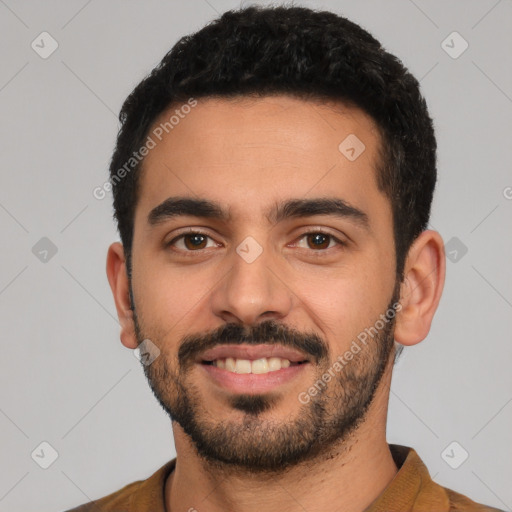 Joyful latino young-adult male with short  black hair and brown eyes