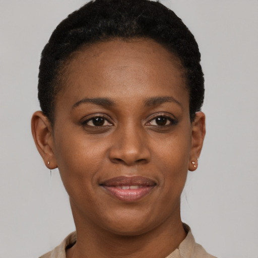 Joyful black young-adult female with short  brown hair and brown eyes