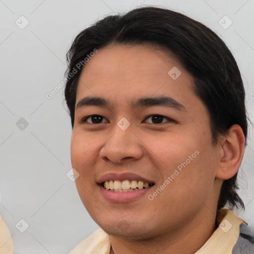 Joyful asian young-adult male with short  black hair and brown eyes