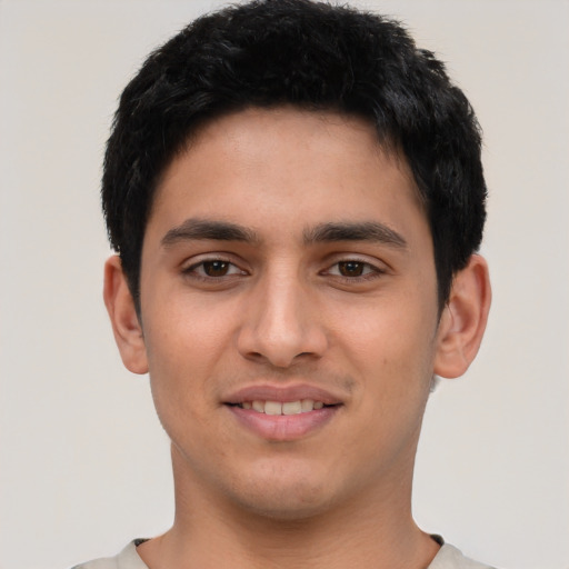Joyful latino young-adult male with short  black hair and brown eyes