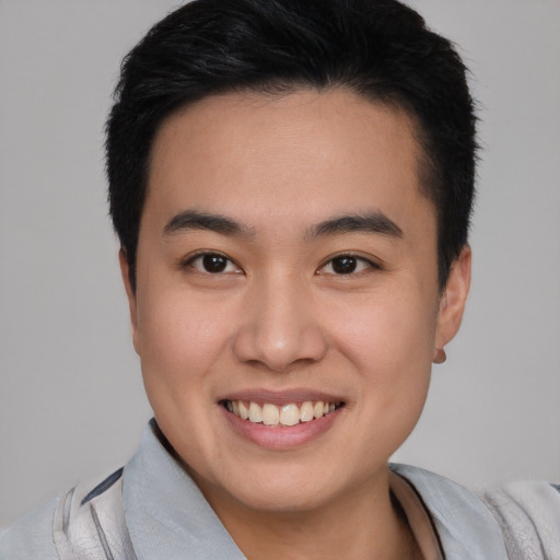 Joyful white young-adult male with short  black hair and brown eyes