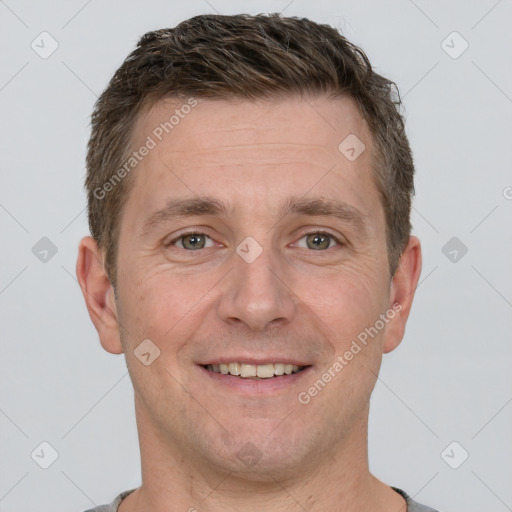 Joyful white adult male with short  brown hair and grey eyes