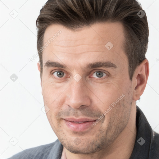 Joyful white adult male with short  brown hair and brown eyes