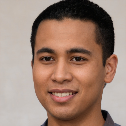 Joyful latino young-adult male with short  brown hair and brown eyes