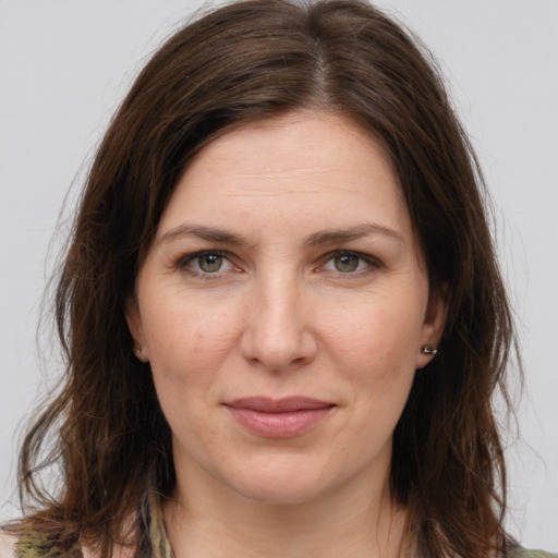 Joyful white young-adult female with long  brown hair and grey eyes