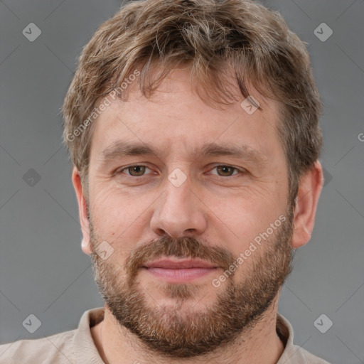 Joyful white adult male with short  brown hair and grey eyes