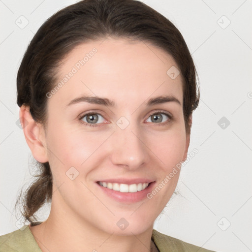 Joyful white young-adult female with medium  brown hair and grey eyes