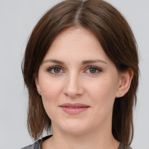 Joyful white young-adult female with medium  brown hair and grey eyes