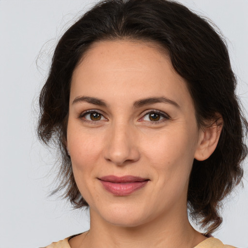 Joyful white adult female with medium  brown hair and brown eyes