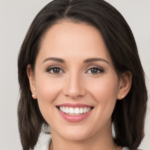 Joyful white young-adult female with medium  brown hair and brown eyes