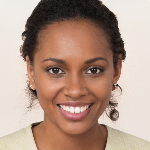 Joyful black young-adult female with short  brown hair and brown eyes