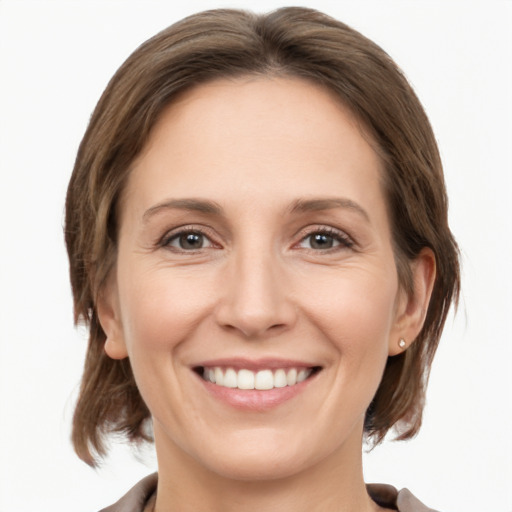 Joyful white young-adult female with medium  brown hair and grey eyes