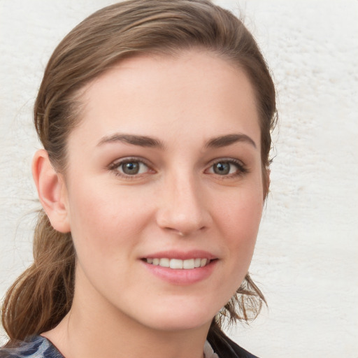 Joyful white young-adult female with long  brown hair and blue eyes