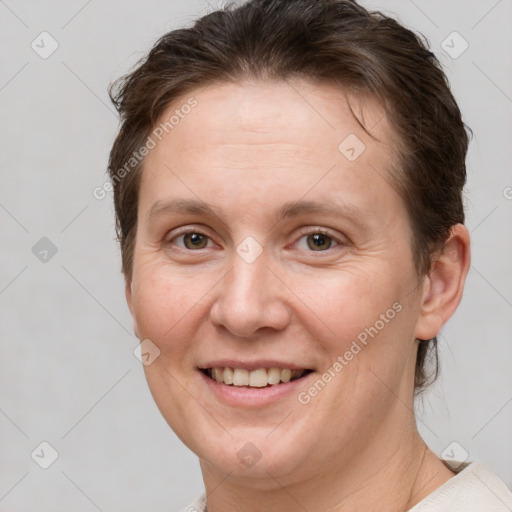 Joyful white adult female with short  brown hair and brown eyes