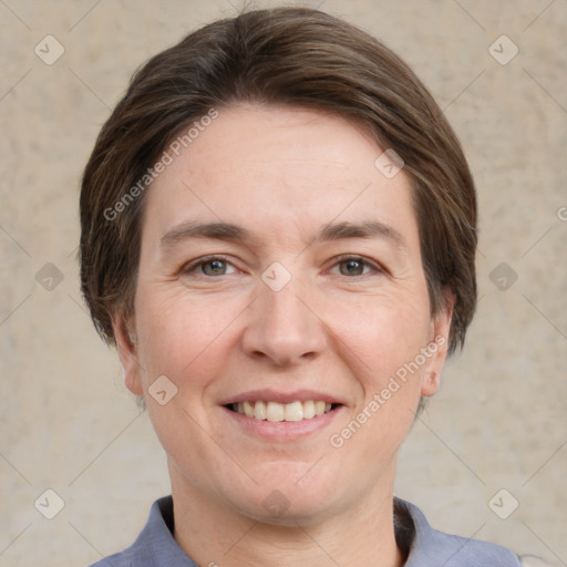 Joyful white adult female with short  brown hair and grey eyes