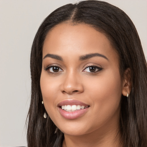 Joyful latino young-adult female with long  black hair and brown eyes