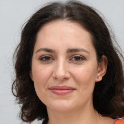 Joyful white adult female with medium  brown hair and brown eyes