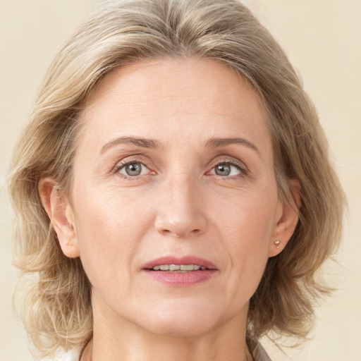 Joyful white adult female with medium  brown hair and grey eyes