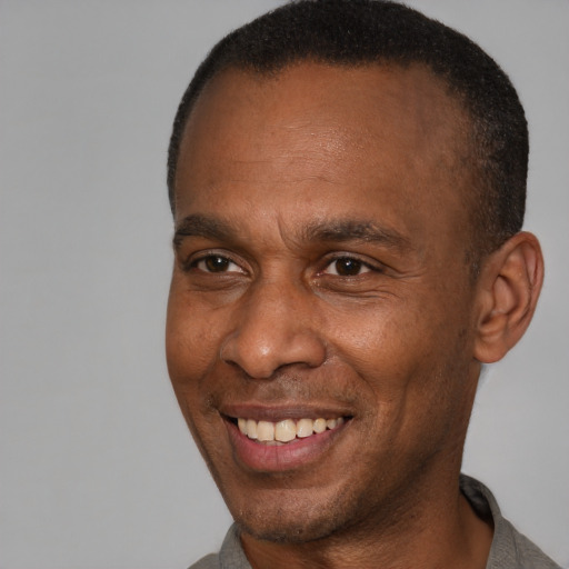 Joyful latino adult male with short  brown hair and brown eyes
