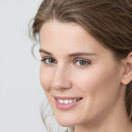 Joyful white young-adult female with medium  brown hair and blue eyes