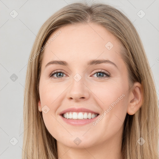 Joyful white young-adult female with long  brown hair and green eyes