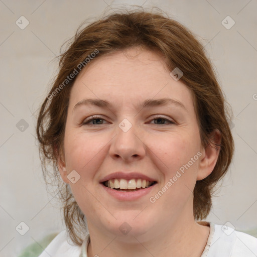 Joyful white young-adult female with medium  brown hair and green eyes