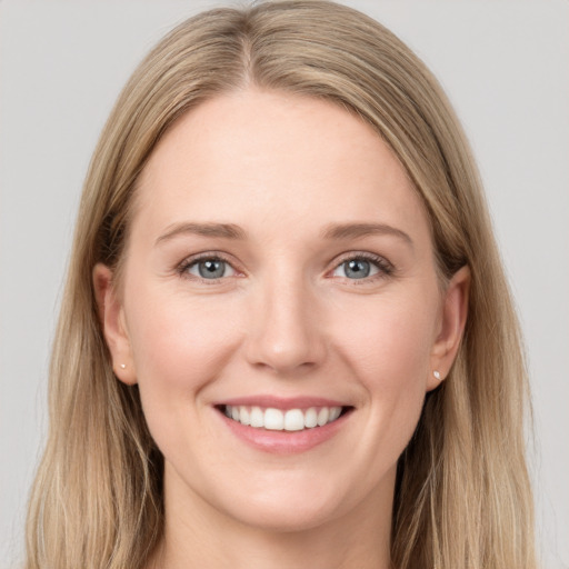 Joyful white young-adult female with long  brown hair and blue eyes