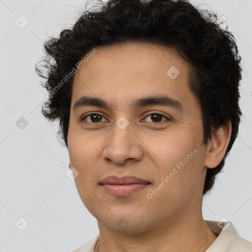 Joyful latino young-adult male with short  brown hair and brown eyes