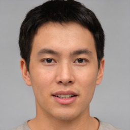 Joyful asian young-adult male with short  brown hair and brown eyes