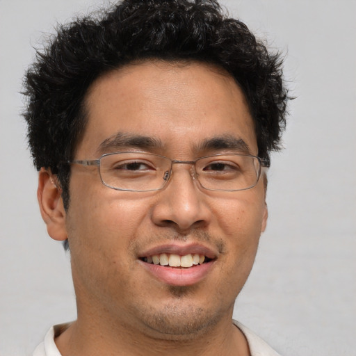 Joyful asian adult male with short  brown hair and brown eyes