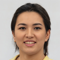 Joyful asian young-adult female with medium  brown hair and brown eyes