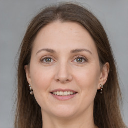 Joyful white adult female with long  brown hair and grey eyes