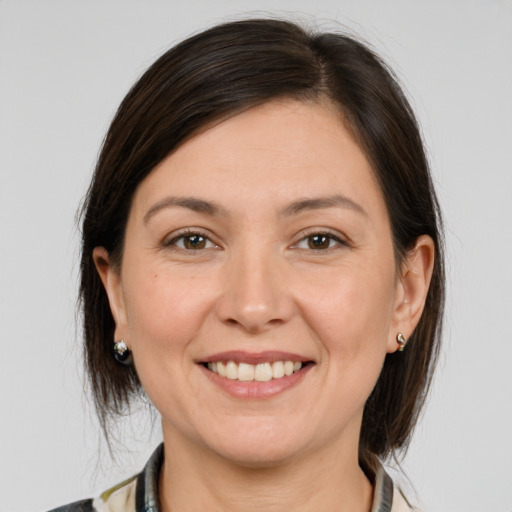 Joyful white young-adult female with medium  brown hair and brown eyes