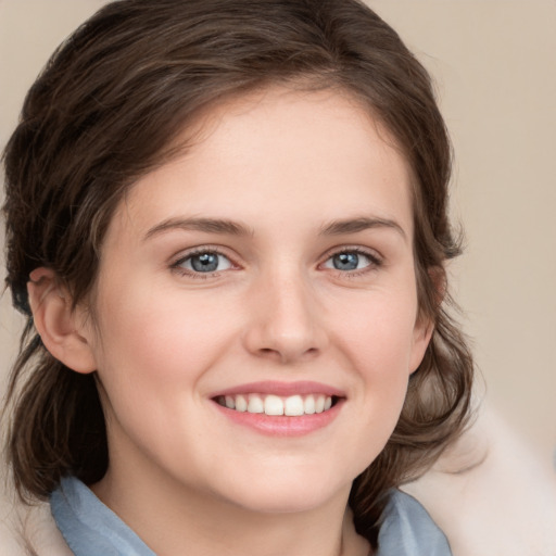 Joyful white young-adult female with medium  brown hair and blue eyes